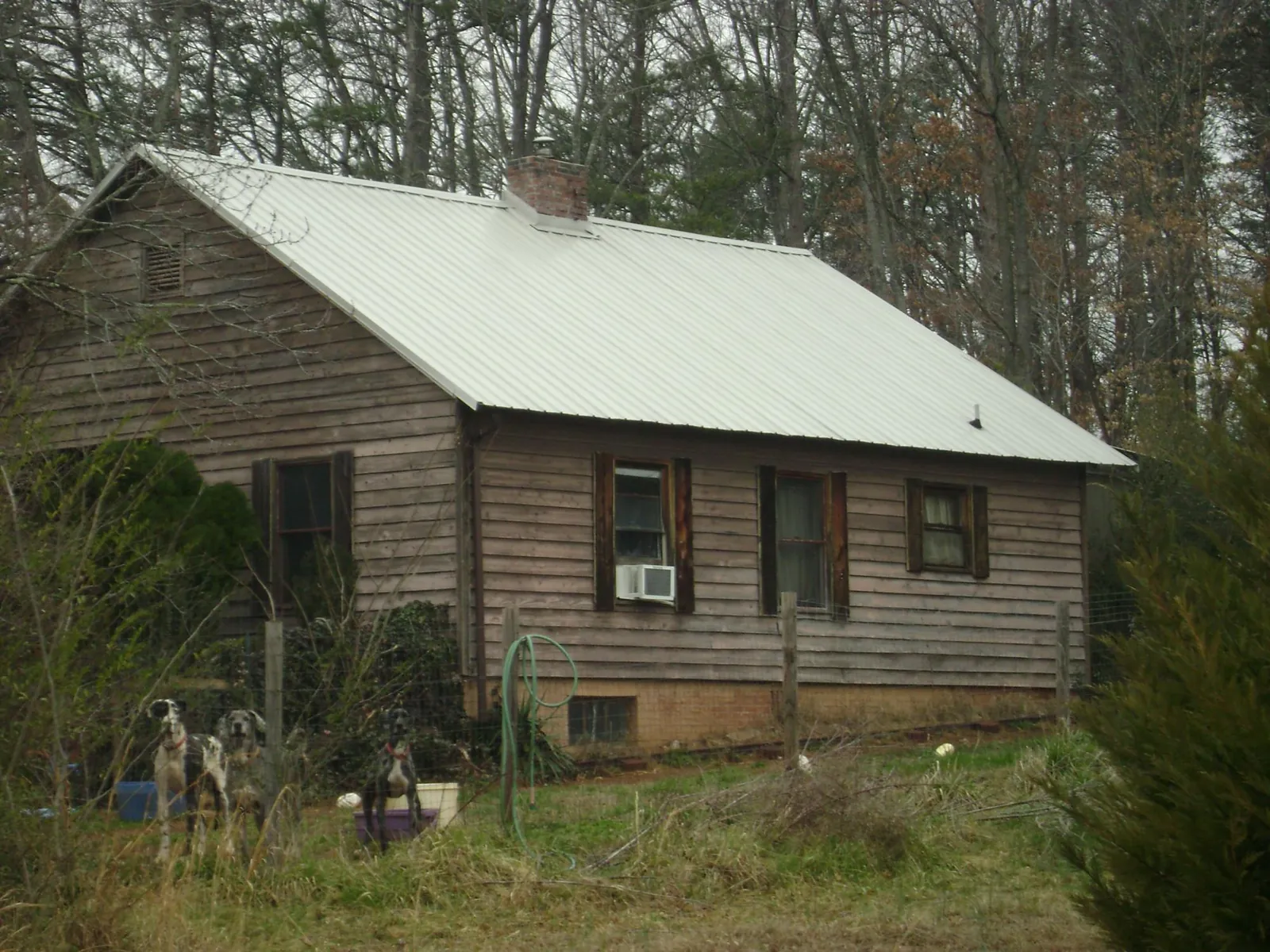 White metal roof on an old wood sided farmhouse, from a Metal Roof Installation job in Marysville